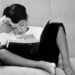 Black and white photo of a young child enjoying a book.